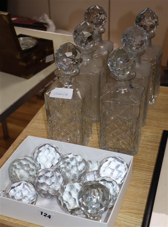 A set of six glass spirit decanters and a quantity of stoppers